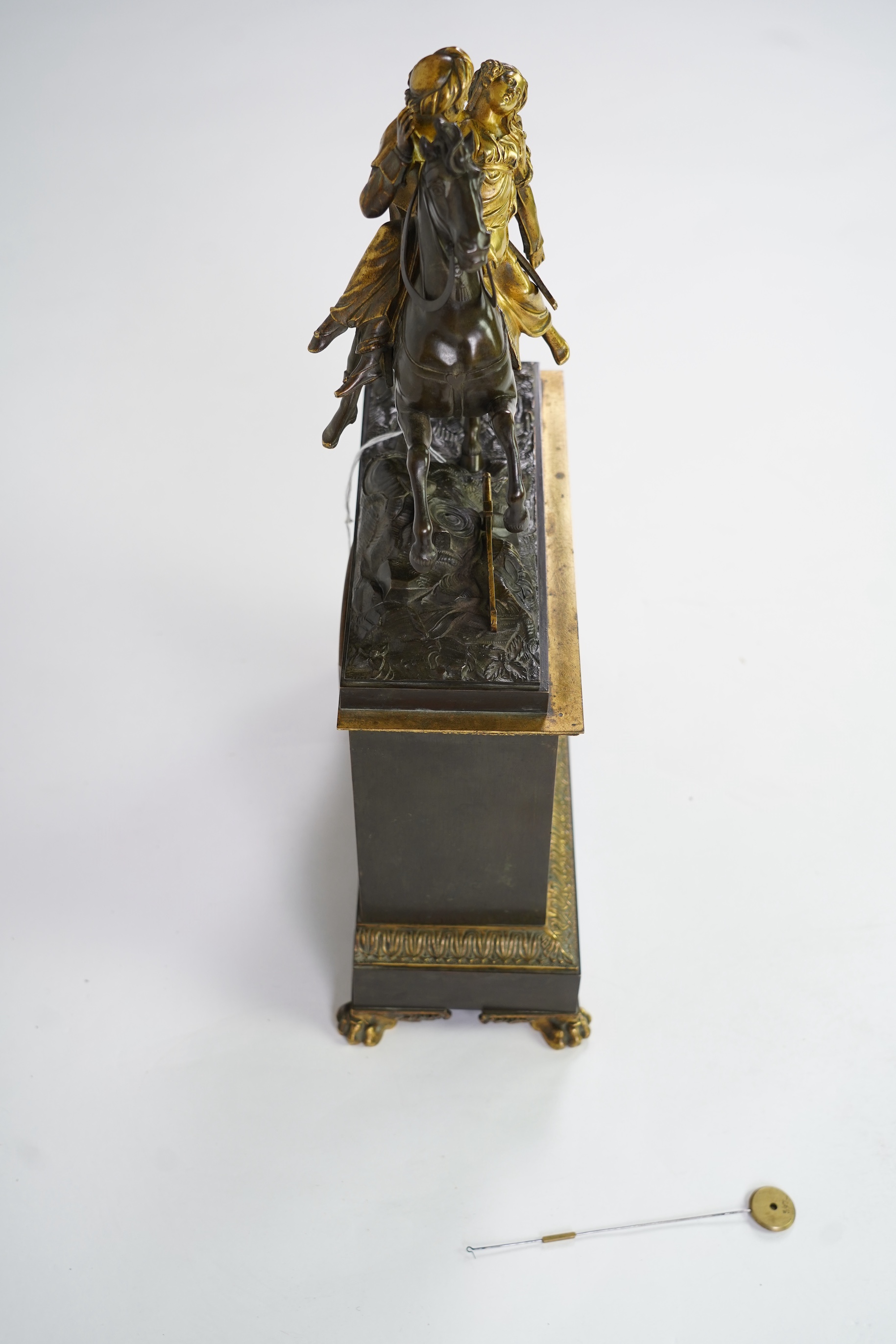 A late nineteenth century brass and bronze cased clock, mounted with a part gilt bronze of a mounted Turkish soldier and woman